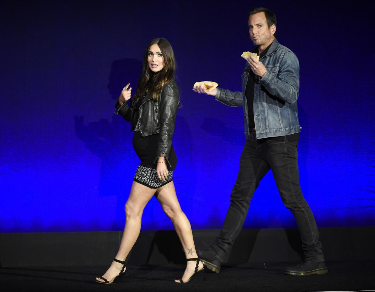 Megan Fox and Will Arnett, cast members in the upcoming film "Teenage Mutant Ninja Turtles: Out of the Shadows," take the stage during the Paramount Pictures presentation at CinemaCon 2016.