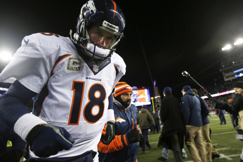 Denver Broncos quarterback Peyton Manning runs off the field after losing in overtime to the New England Patriots, 34-31, on Sunday night. Manning says the Broncos need to learn from the gut-wrenching loss.