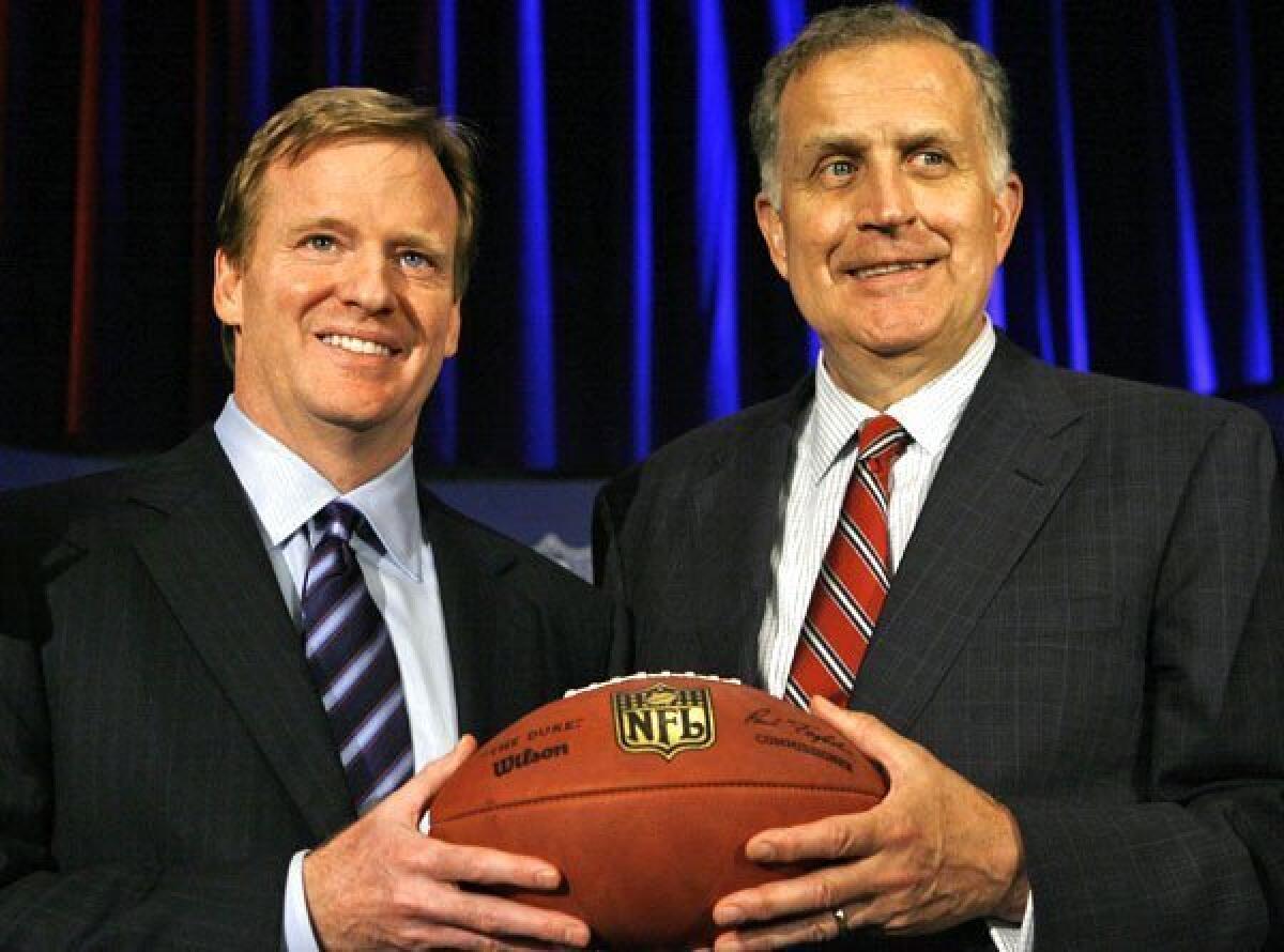 Former NFL commissioner Paul Tagliabue, right, hands off to incoming Commissioner Roger Goodell in 2006.