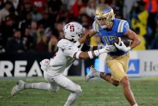 PASADENA, CALIF. - OCT. 29, 2022. UCLA wide receiver Matt Sykes makes a catch in front of Stanford cornerback.