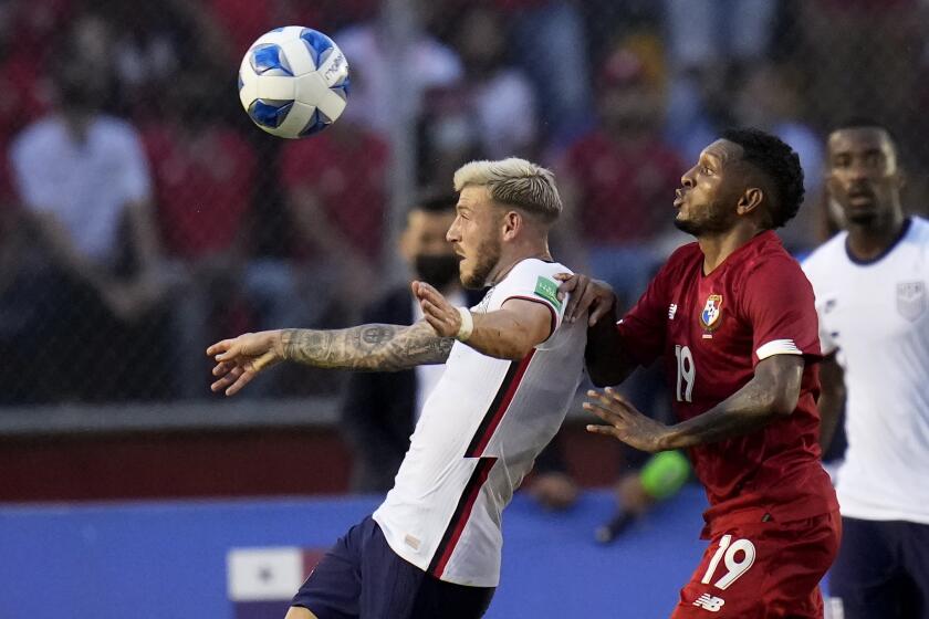 United States´ Paul Arriola, left, and Panama's Alberto Quintero battle for the ball during a qualifying soccer match for the FIFA World Cup Qatar 2022 at Rommel Fernandez stadium, Panama city, Panama, Sunday, Oct. 10, 2021. (AP Photo/Arnulfo Franco)