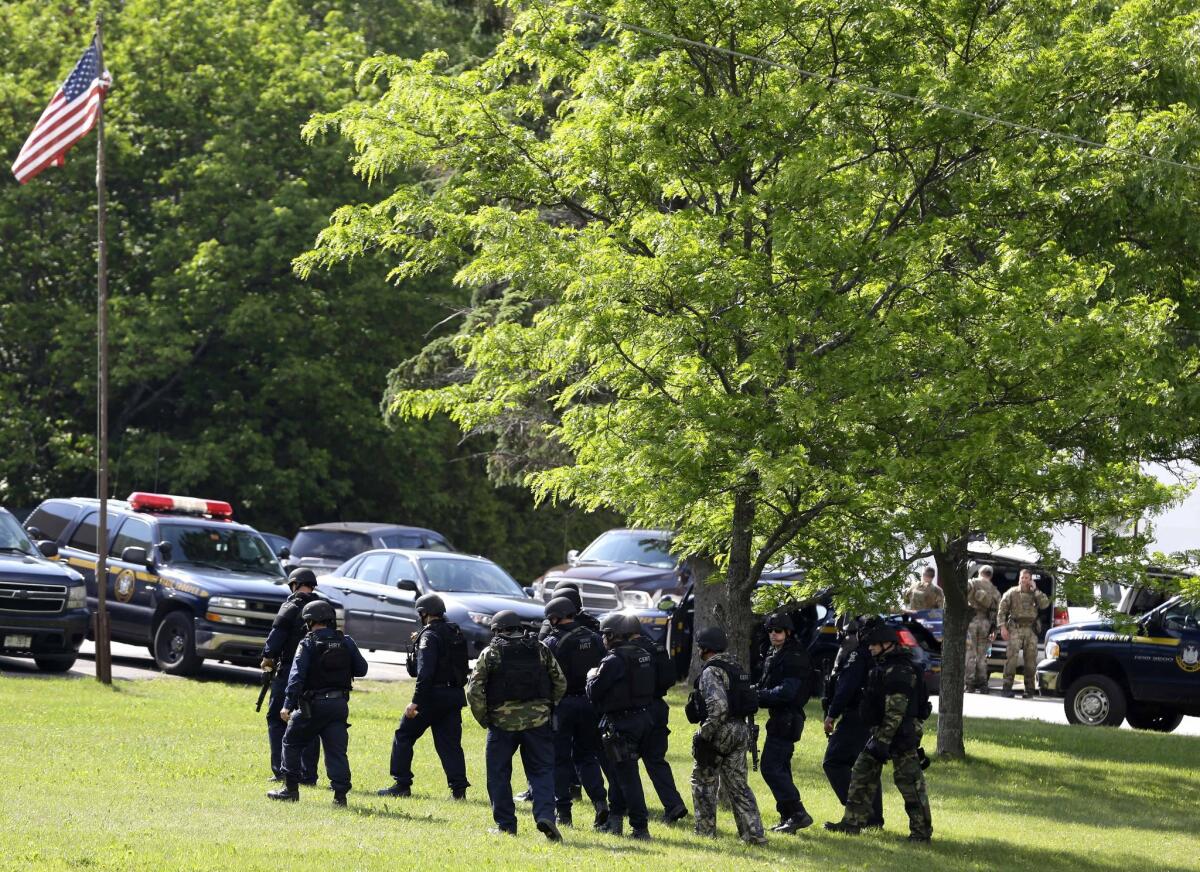 Heavily armed law enforcement officers prepare to resume search for two escaped murderers near Dannemora, N.Y., on June 11, 2015.