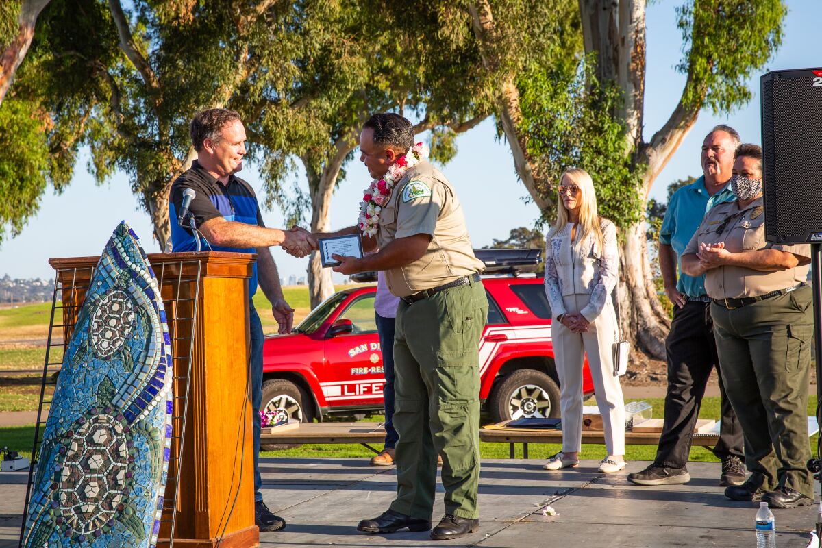 Mission Bay Park Ranger Iggy Sorenseene is congratulated for his work serving Pacific Beach. 