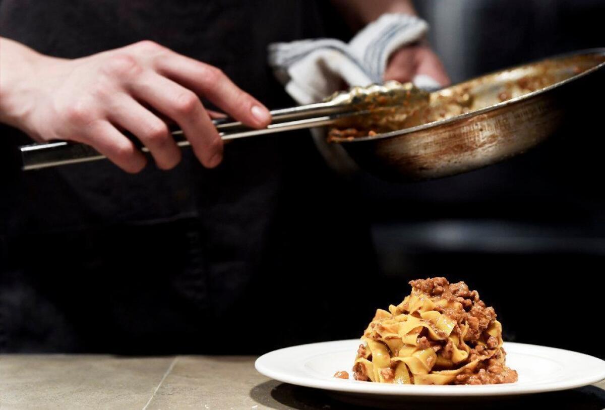 A chef puts the finishing touches on fettuccine.