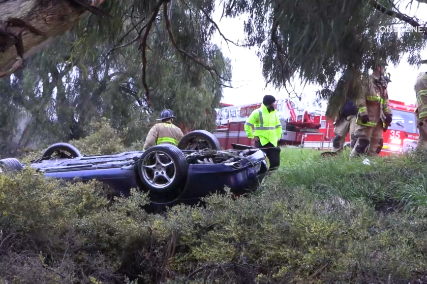 A driver was extricated from an overturned vehicle early Wednesday after crashing off Interstate 5 south of Gilman Drive.
