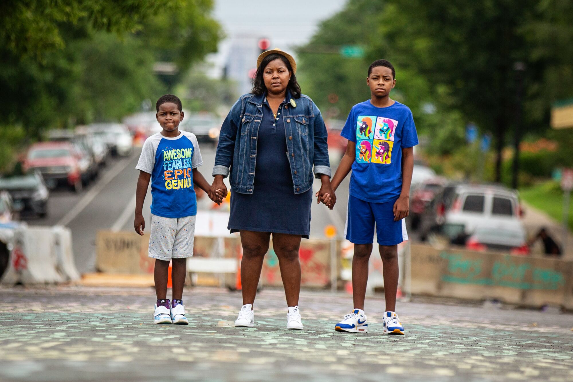 Alicia Smith and sons Alonzo, 7, left, and Walter III, 11, stand near where George Floyd was killed in South Minneapolis