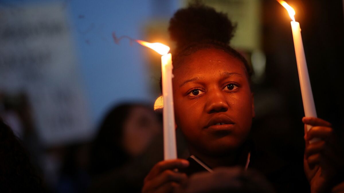 A Black Lives Matter protester attends a vigil in Sacramento for police shooting victim Stephon Clark.