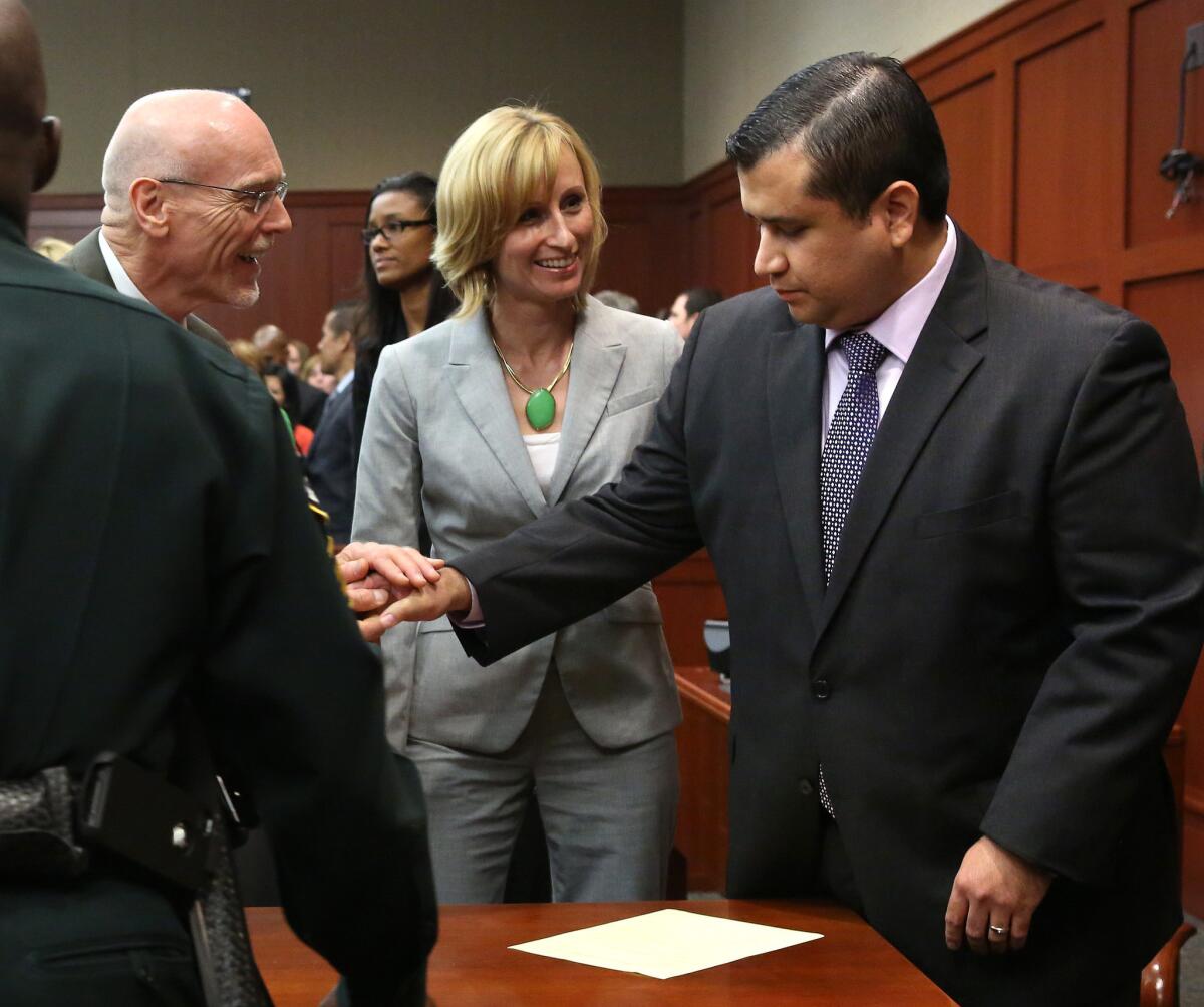 George Zimmerman is congratulated by his defense team after being found not guilty, on the 25th day of Zimmerman's trial at the Seminole County Criminal Justice Center, in Sanford, Fla. on Saturday.