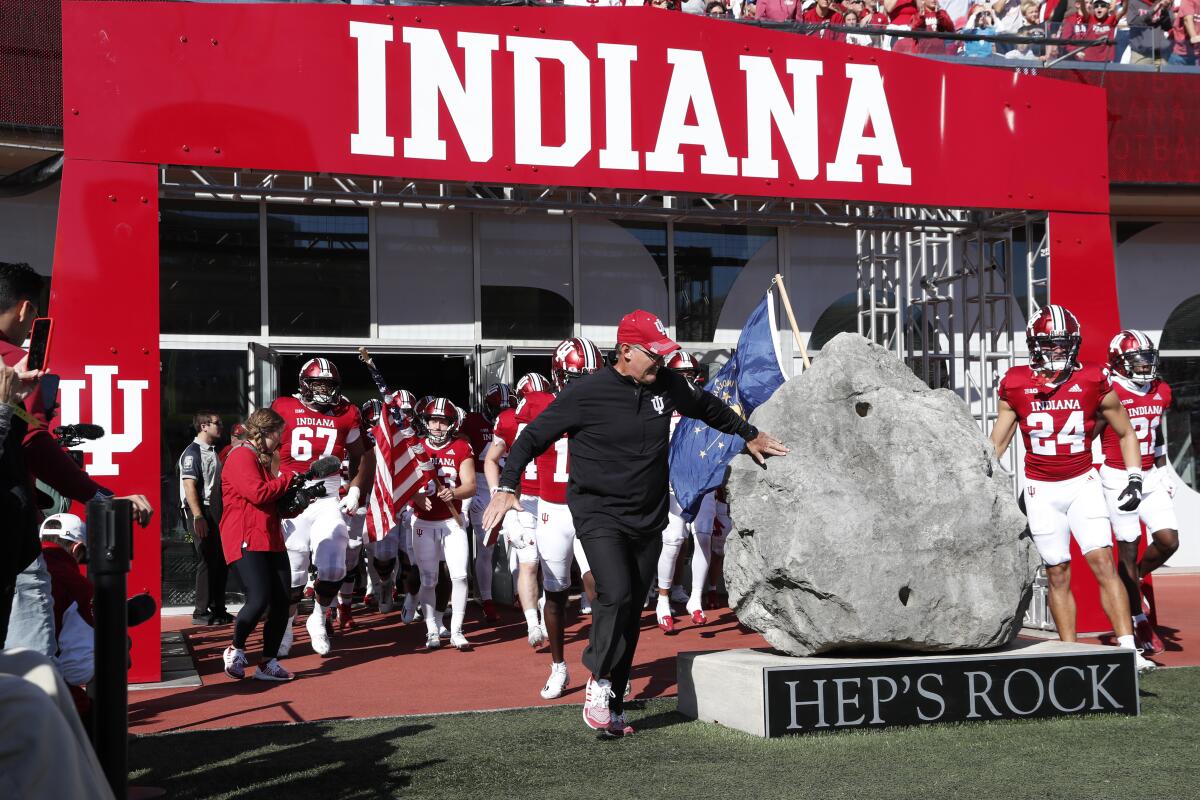 Indiana football players and coaches touch Hep's Rock, a Memorial Stadium staple