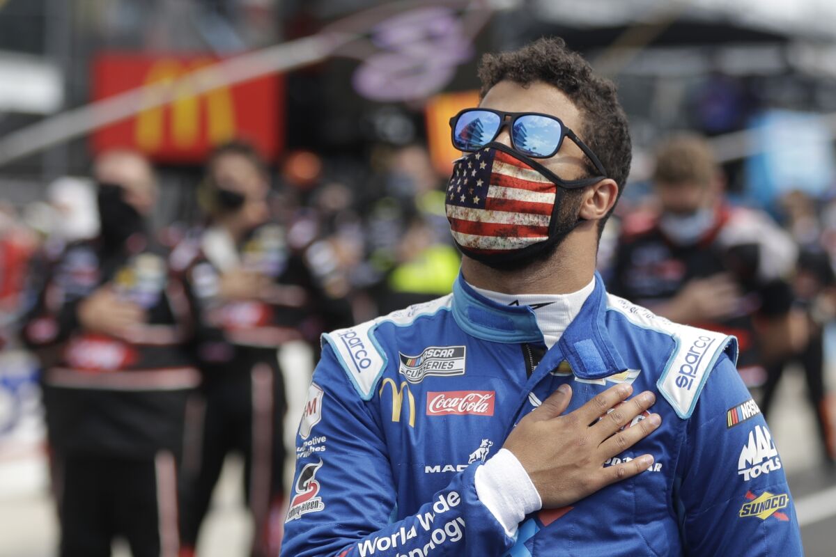 NASCAR driver Bubba Wallace stands during the national anthem before a race at Indianapolis Motor Speedway on Sunday.
