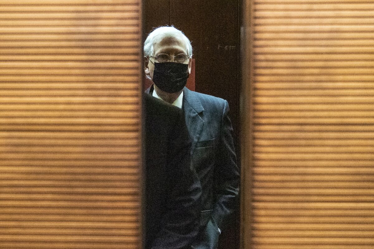 Senate Majority Leader Mitch McConnell wears a mask after a meeting on Capitol Hill. 