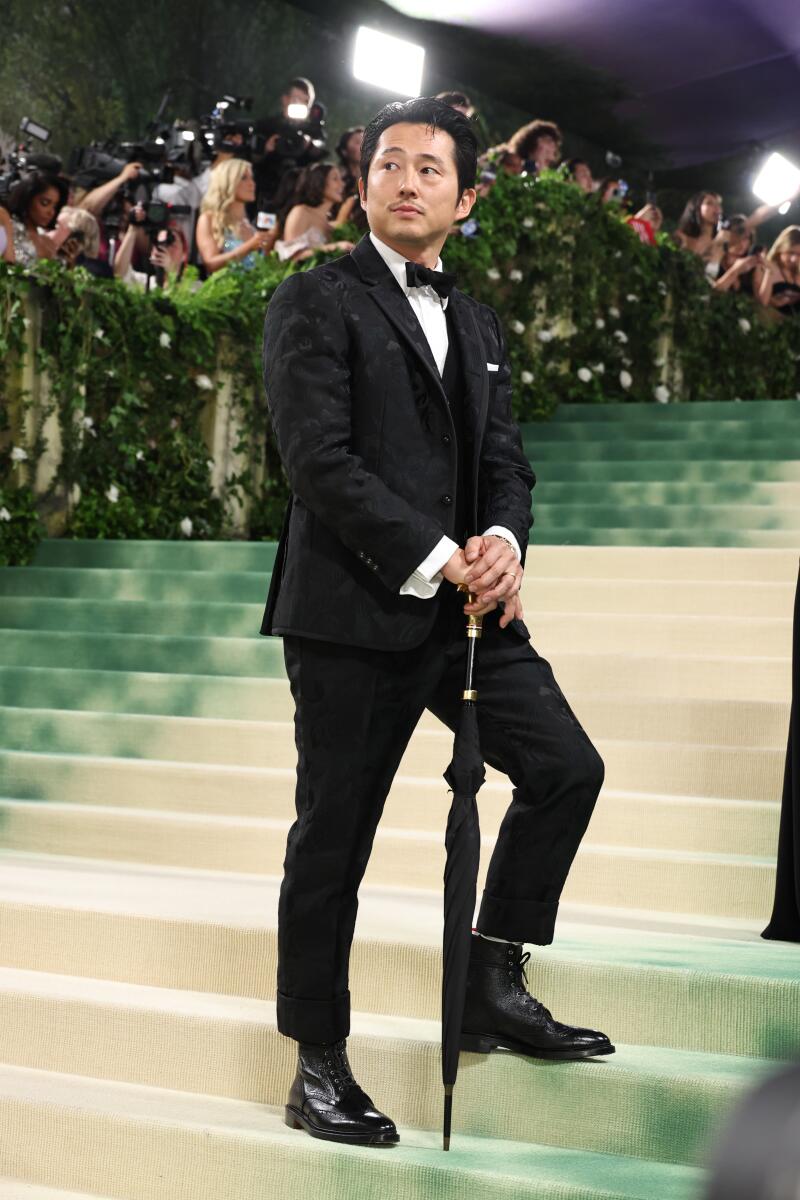 Steven Yeun’s character in “Beef” wouldn’t recognize himself on the Met’s carpet. He’s wearing a custom Thom Browne three-piece suit cut from a jacquard fabric with a pattern of ravens and roses.