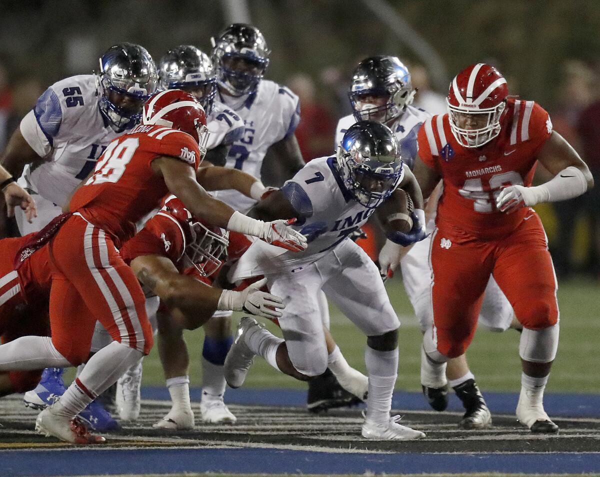 IMG Academy running back Noah Cain tears through the Mater Dei defense in the first quarter Friday.