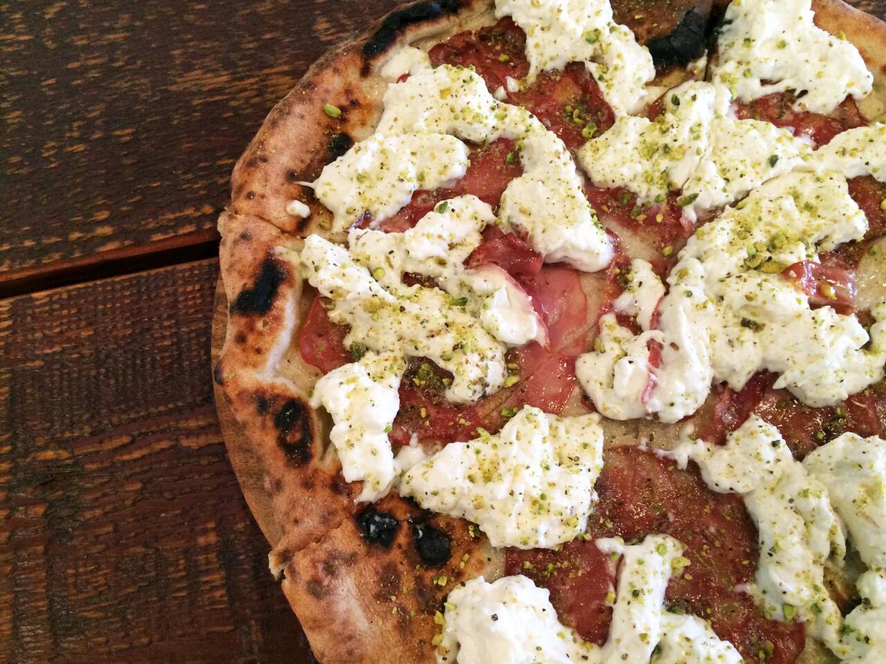 A pizza topped with mortadella, stracciatella and pistachio nuts at Prova Pizzeria.