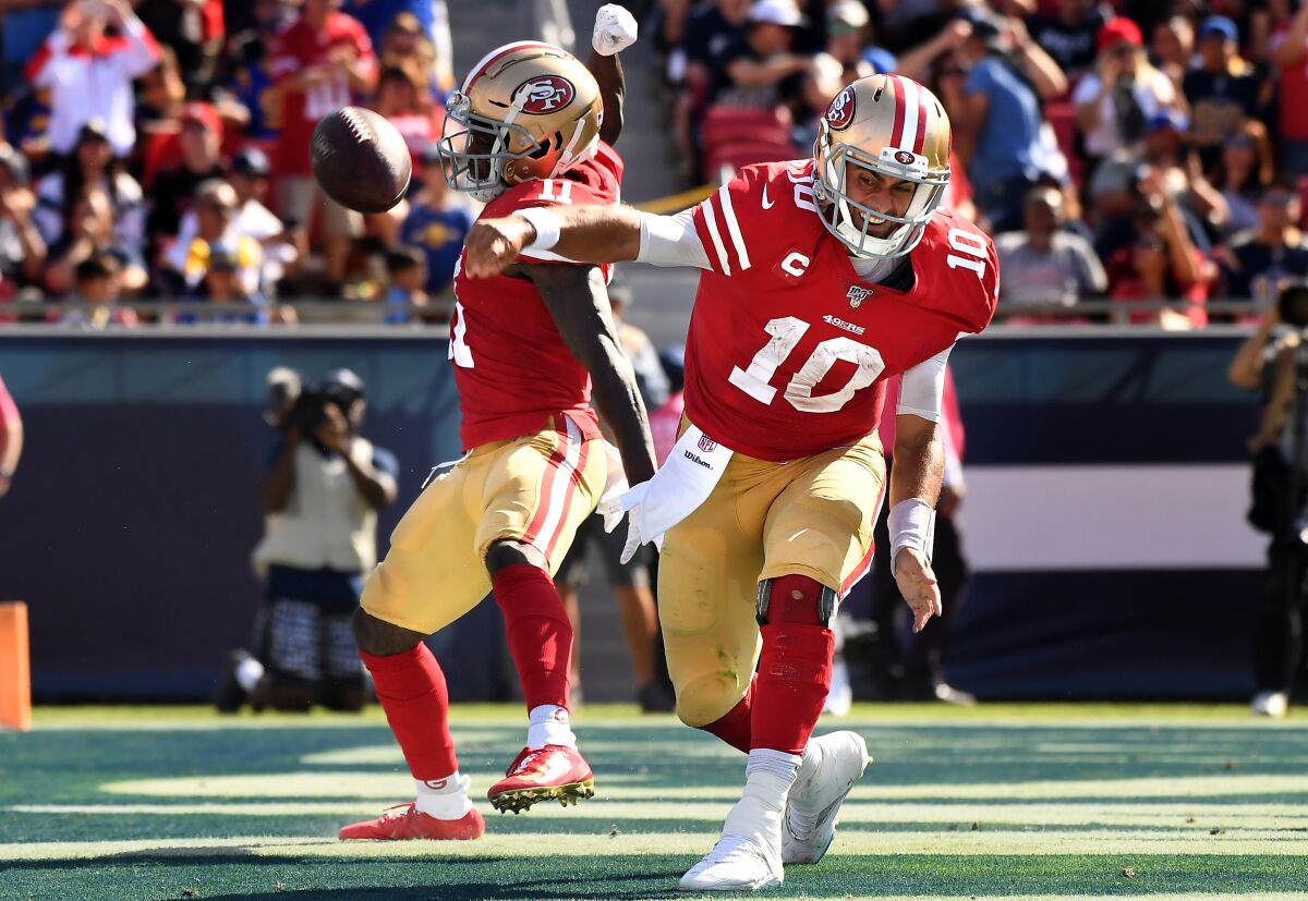 San Francisco 49ers quarterback Jimmy Garoppolo spikes the football after sneaking for a touchdown against the Rams.