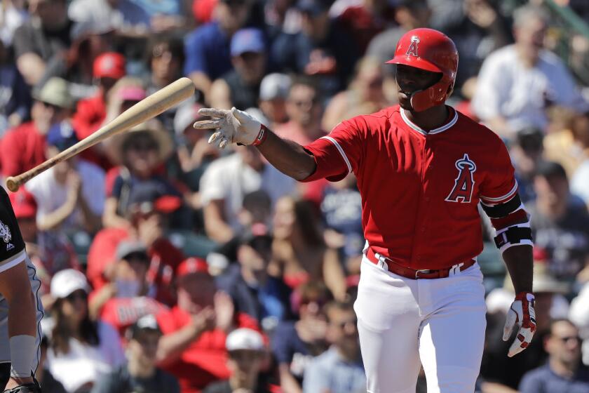 Los Angeles Angels' Justin Upton tosses aside his bat after walking against the Chicago White Sox in a spring training baseball game Friday, March 22, 2019, in Tempe, Ariz. (AP Photo/Elaine Thompson)