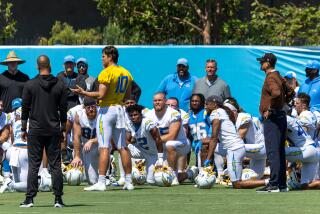 Chargers quarterback Justin Herbert (10) address the team.