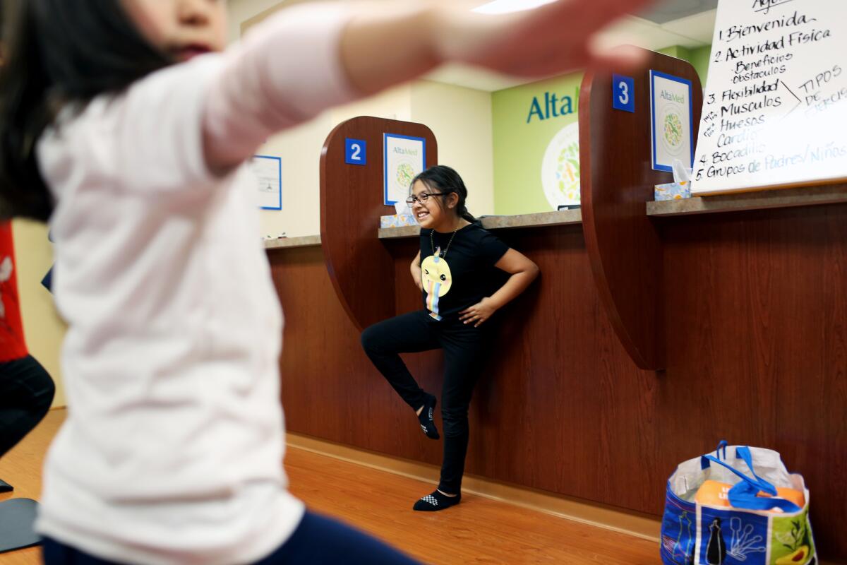 Irie leads participants in exercise at BodyWorks, a family-based lifestyle intervention program by Children's Hospital Los Angeles and AltaMed. (Dania Maxwell / Los Angeles Times)