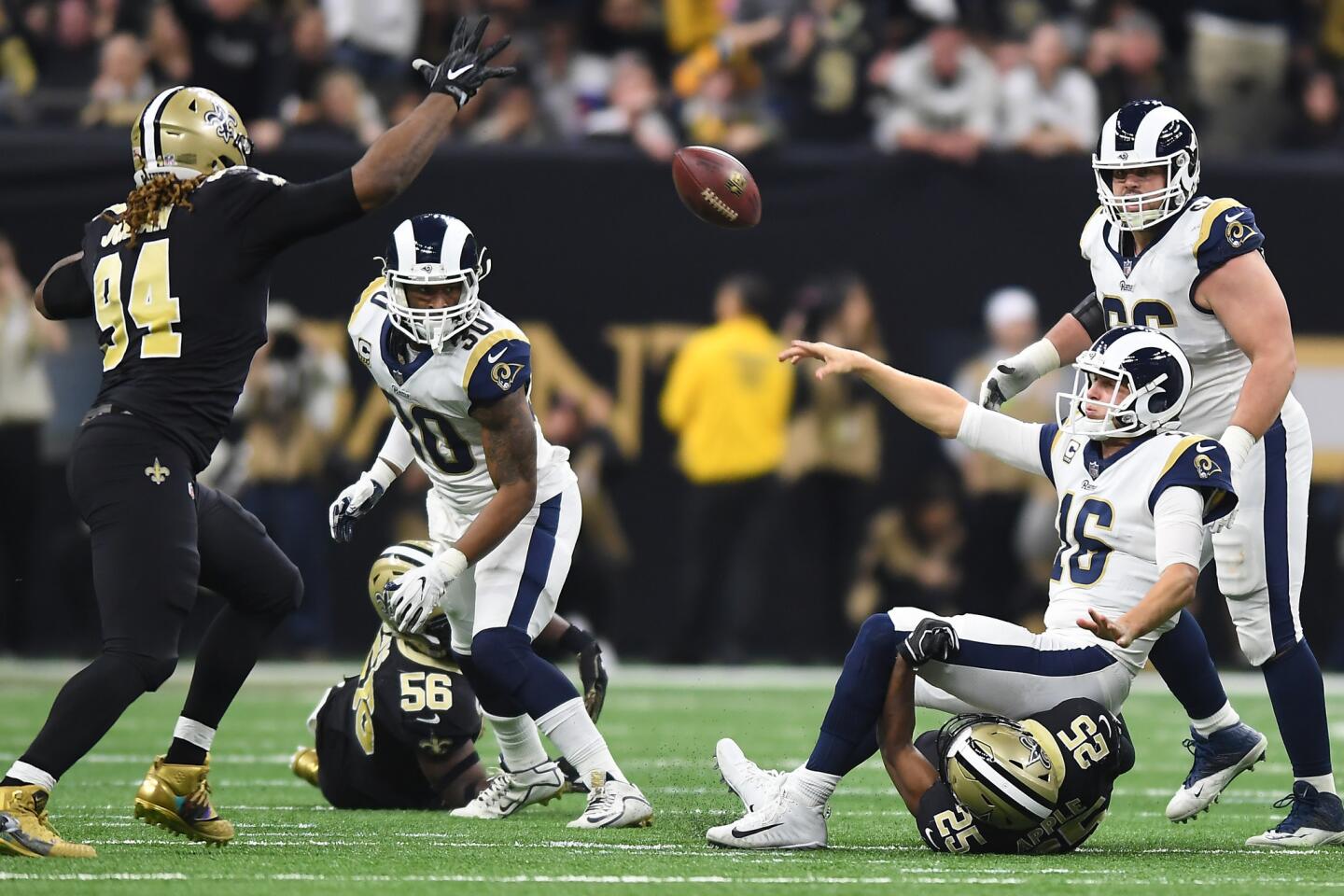 Rams quarterback Jared Goff makes a completion despite being tackled by New Orleans Saints' Eli Apple in the second quarter in the NFC Championship at the Superdome in New Orleans Sunday.
