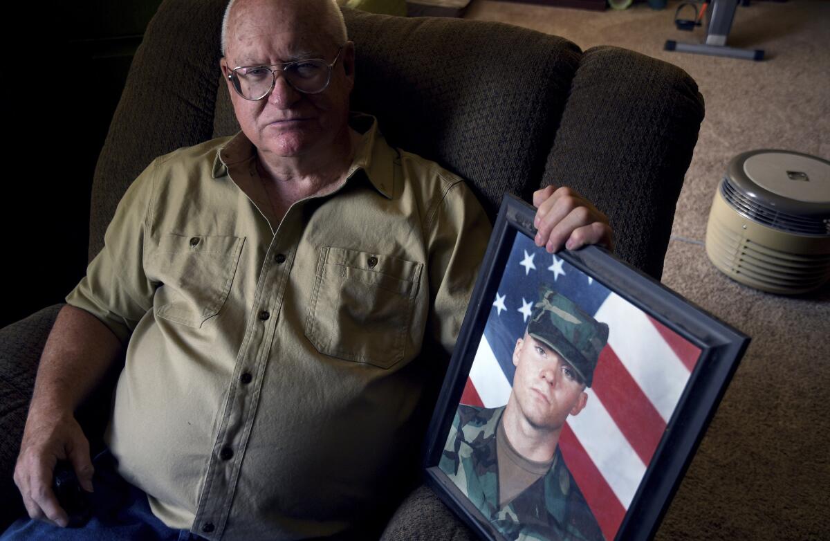 Donn Edmunds, a 25-year U.S. Army veteran who served in Vietnam, sits for a portrait in his living room in Cheyenne, Wyo., Wednesday, Sept. 1, 2021. Edmunds' son, Army Ranger Spc. Jonn Edmunds, and another soldier died when a Black Hawk helicopter on a search-and-rescue mission crashed in Pakistan in October 2001. They were among the first U.S. casualties in the Afghanistan war. (AP Photo/Thomas Peipert)