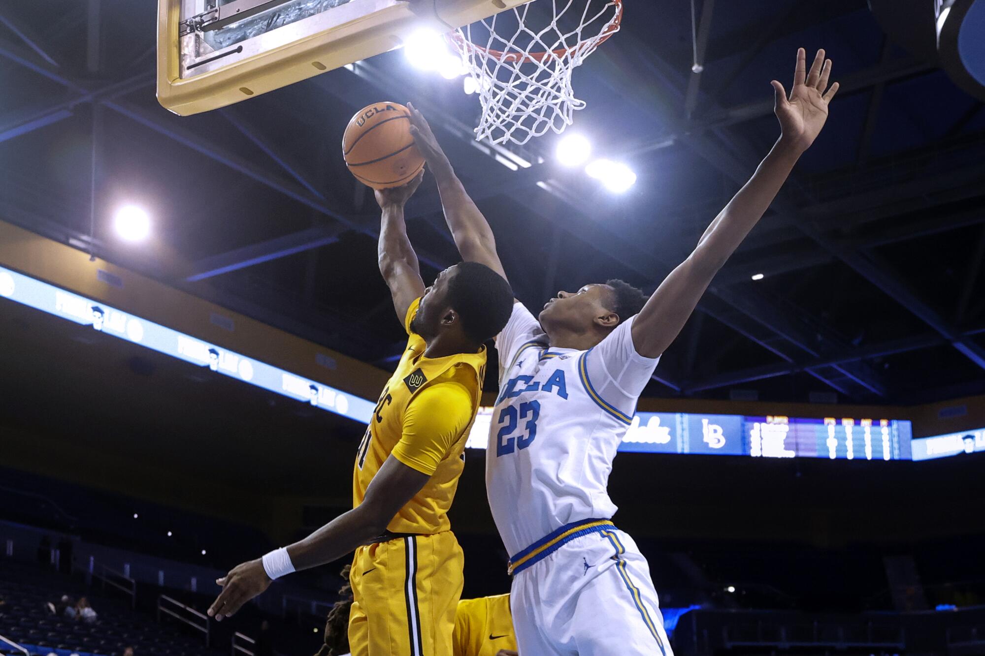 UCLA guard Peyton Watson blocks a shot.