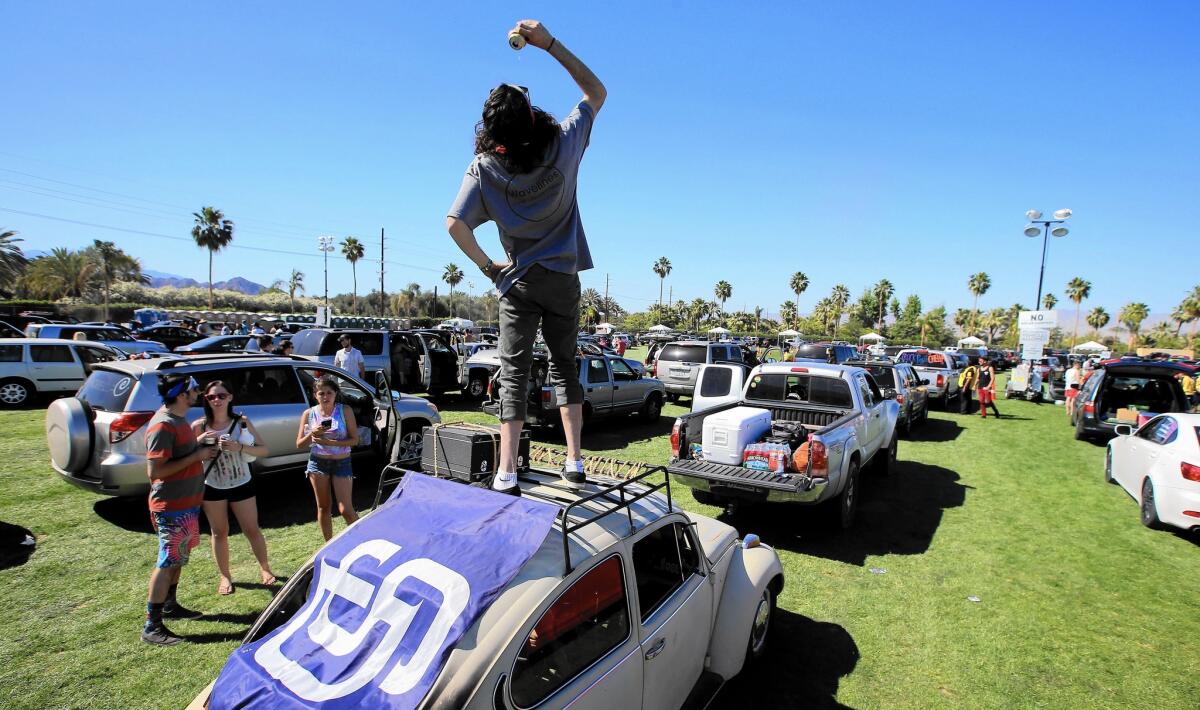 Chris Heredia, 19, of San Diego gets the party started as cars and people descend on the Empire Polo Grounds in Indio for the three-day Coachella Music and Arts Festival, which starts Friday.