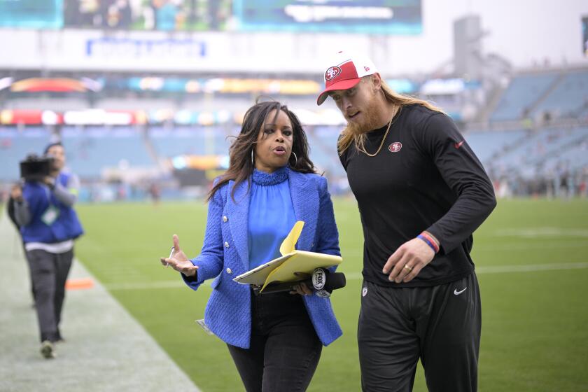 Fox Sports sideline reporter Pam Oliver talks with San Francisco 49ers tight end George Kittle on the field 