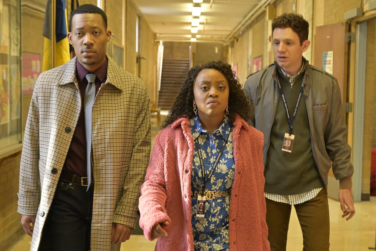 Tyler James Williams, left, Quinta Brunson and Chris Perfetti walk down a school hallway in "Abbott Elementary."