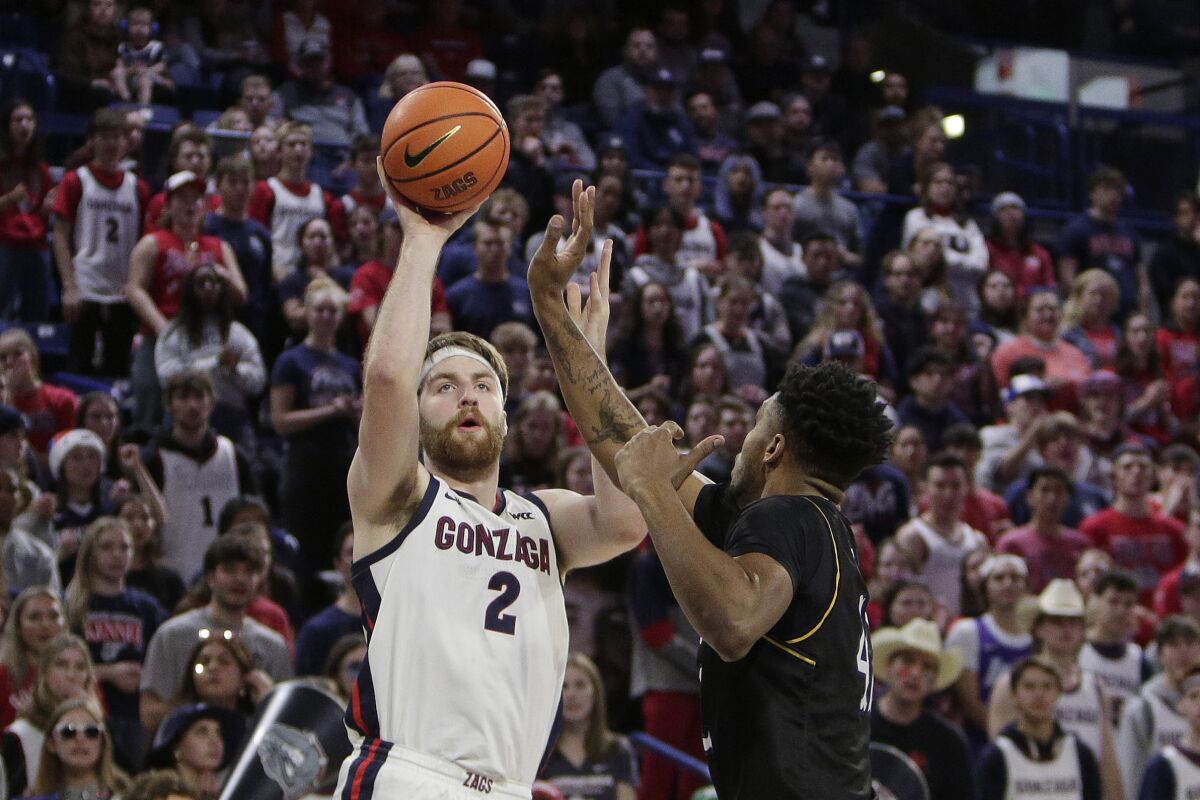 Gonzaga forward Drew Timme, left, shoots while defended by Kent State center Cli'Ron Hornbeak during the first half of an NCAA college basketball game, Monday, Dec. 5, 2022, in Spokane, Wash. (AP Photo/Young Kwak)
