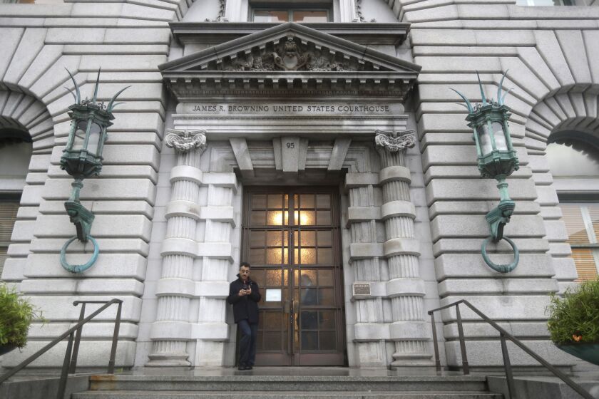 A man stands outside the main door outside the 9th U.S. Circuit Court of Appeals building Thursday, Feb. 9, 2017, in San Francisco. A federal appeals court refused Thursday to reinstate President Donald Trump's ban on travelers from seven predominantly Muslim nations, dealing another legal setback to the new administration's immigration policy. (AP Photo/Marcio Jose Sanchez)