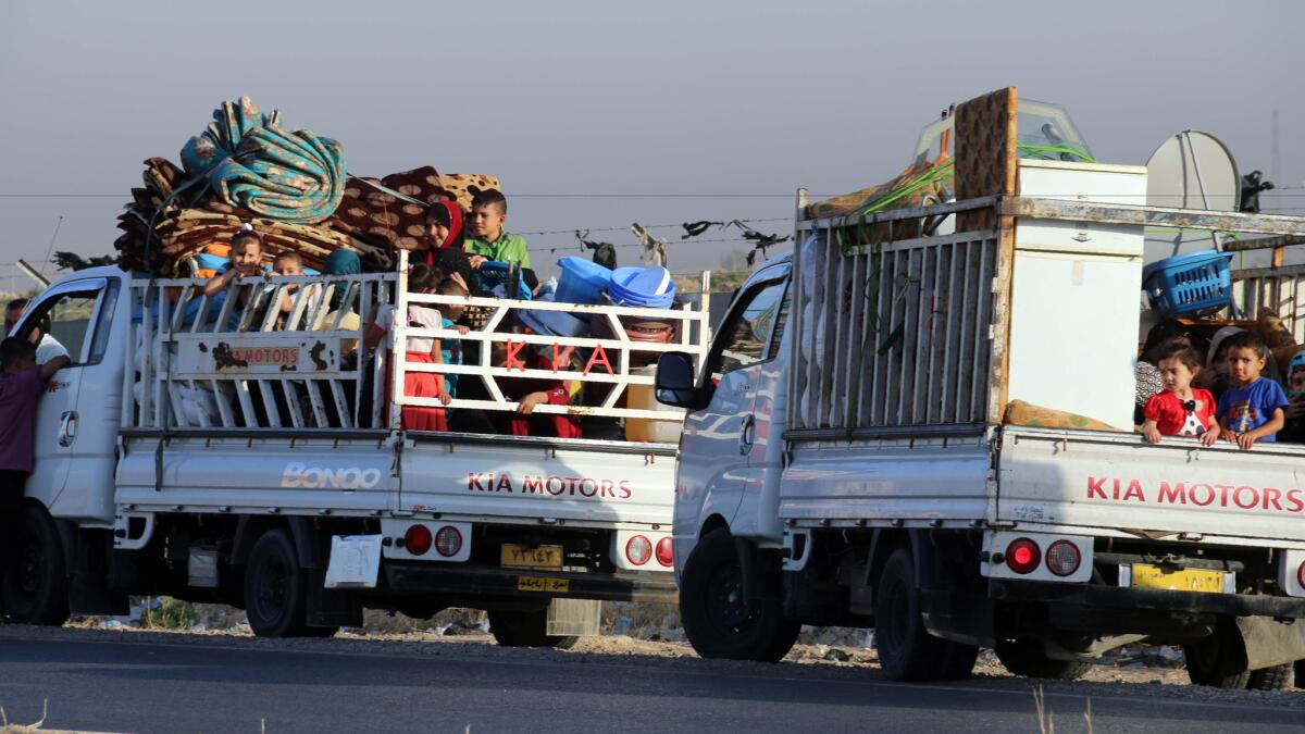 Iraqi families who took refuge in Kirkuk prepare to return to their homes in Sharqat after government forces recaptured the town from ISIS.