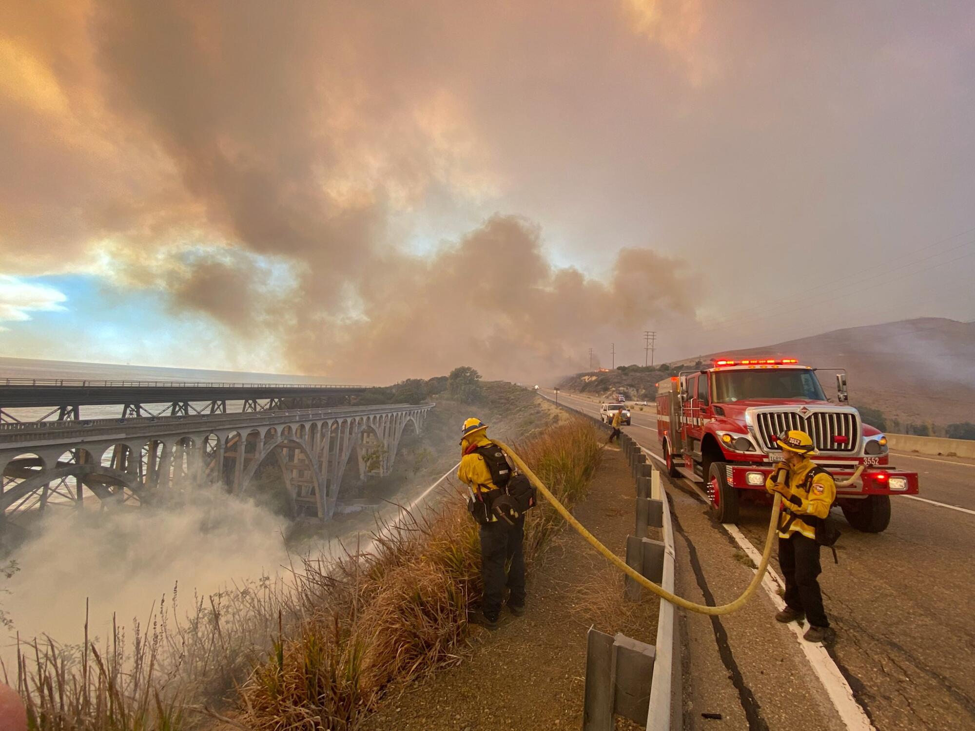 Firefighters with a hose