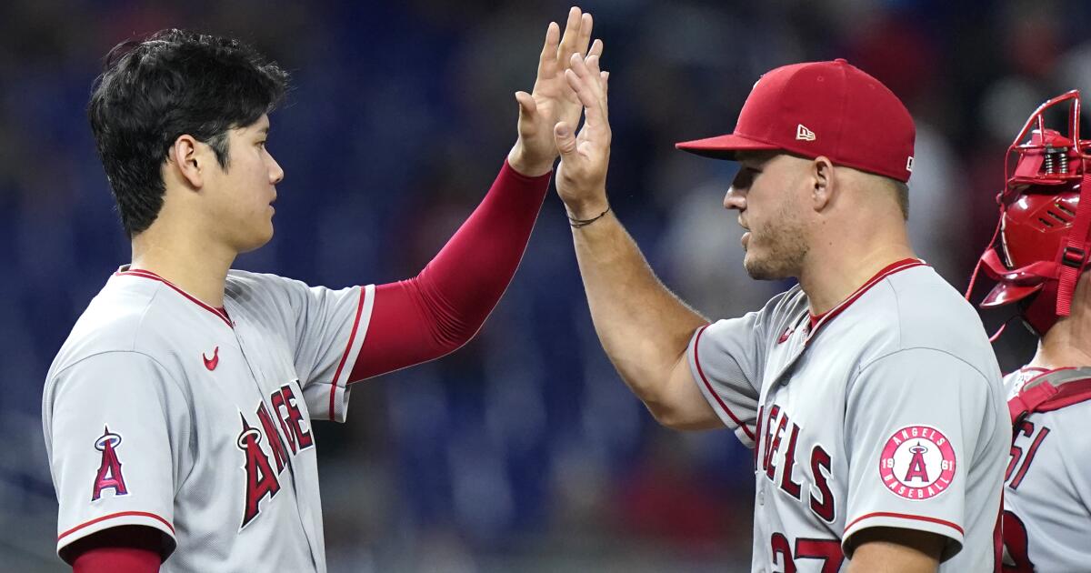 Los Angeles Angels' Hunter Renfroe (12) is greeted by Mike Trout