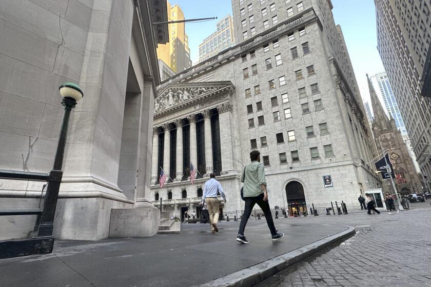 FILE - People approach the New York Stock Exchange on Aug. 27, 2024, in New York. (AP Photo/Peter Morgan, File)