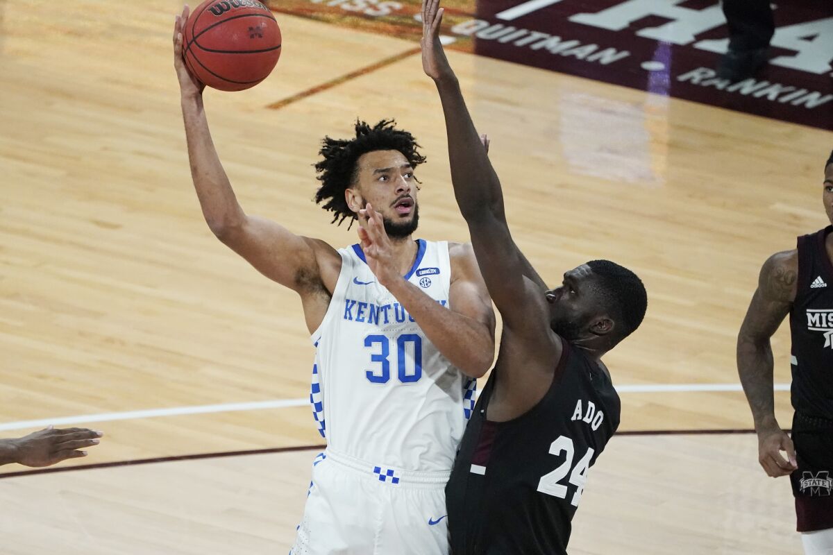 Kentucky forward Olivier Sarr (30) hooks a shot over Mississippi State forward Abdul Ado (24) during the second half of an NCAA college basketball game in Starkville, Miss., Saturday, Jan. 2, 2021. (AP Photo/Rogelio V. Solis)