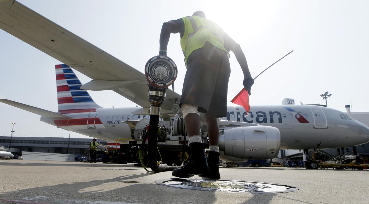 Scott Mills finishes fueling up an American Airlines jet at Dallas/Fort Worth International Airport in 2015. Fuel costs for the airline rose 23% in the fourth quarter of 2017 compared with the same period in 2016.