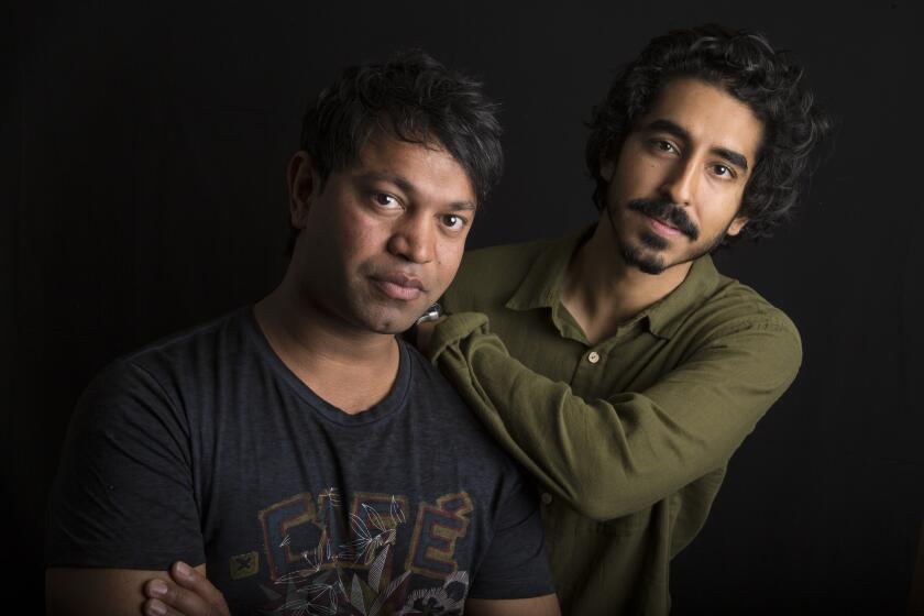 Saroo Brierley, left, poses with Dev Patel, the actor who plays him in the movie "Lion."