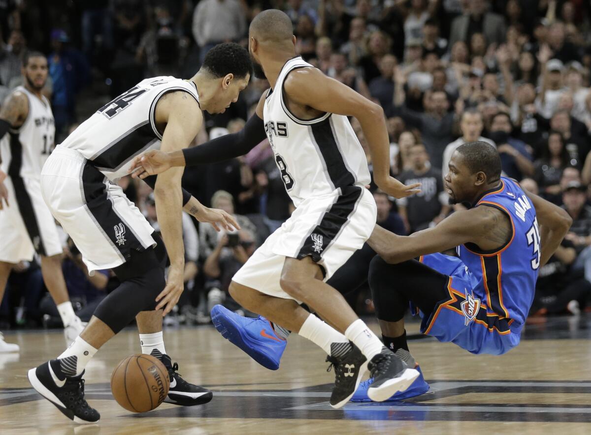 Oklahoma City forward Kevin Durant loses an inbound pass to San Antonio guard Danny Green, left, on Monday night.