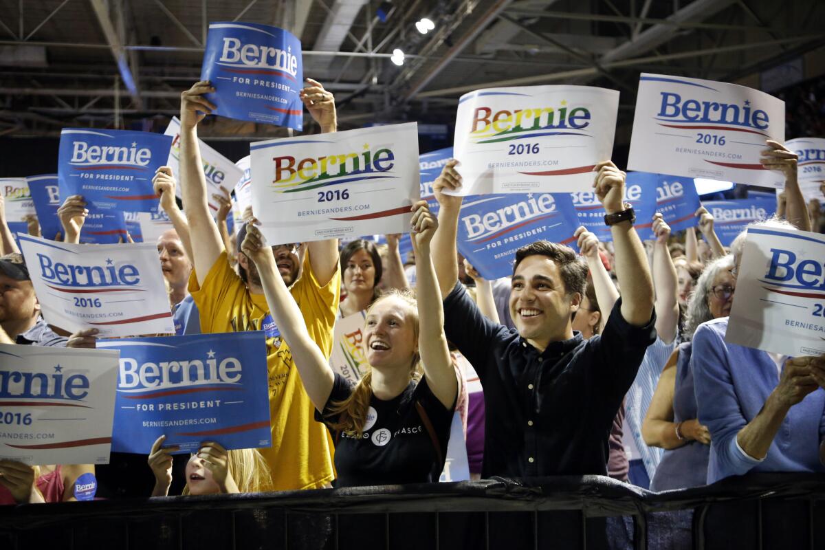 Supporters of Democratic presidential candidate Bernie Sanders cheer at a campaign rally in Portland, Maine.
