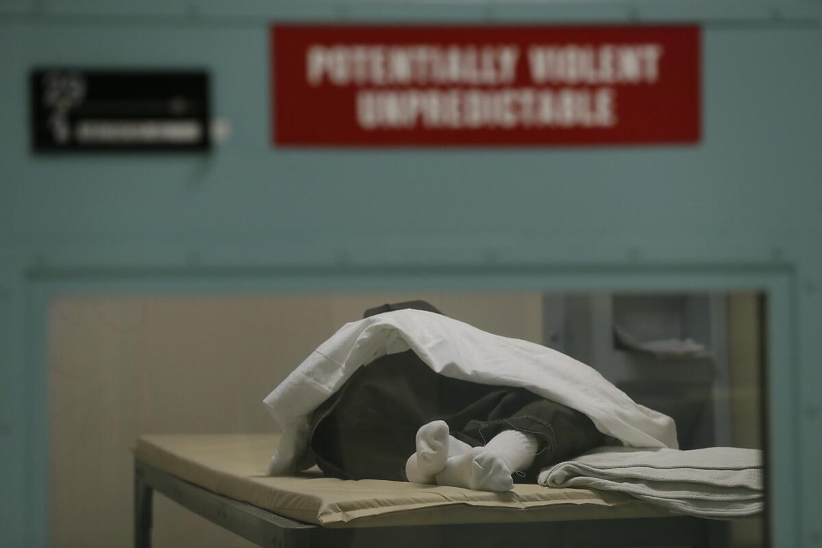 An inmate sleeps in a room on the 4th floor of the medical unit of the Twin Towers Correctional Facility. This area houses inmates with the highest level of need -- both psychiatric and medical.