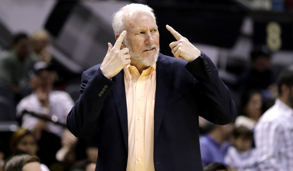 San Antonio Spurs Coach Gregg Popovich, sporting a beard this season, directs his team during a preseason game against the Sacramento Kings.