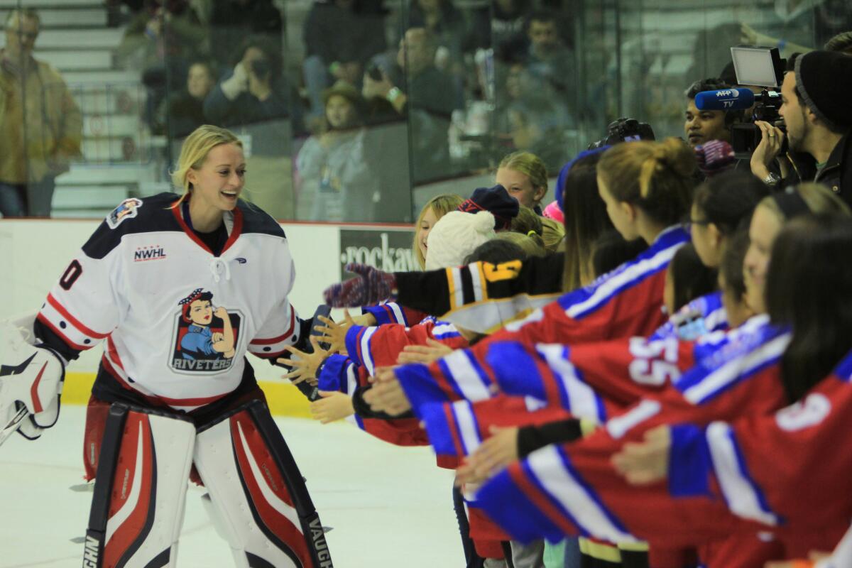 New York Riveters goalie Jenny Scrivens shakes hands with NWHL fans.