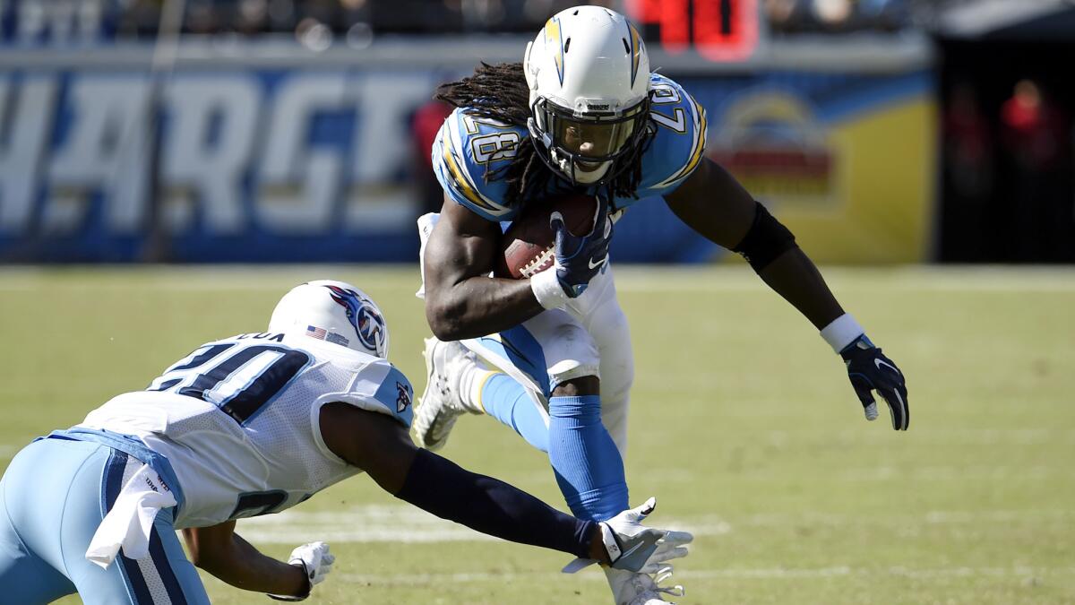 Chargers running back Melvin Gordon tries to hurdle Titans cornerback Perrish Cox during the first half.