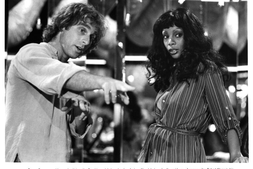 Director Robert Klane instructs actress Donna Summer on the set of the Columbia Pictures movie " Thank God It's Friday" in 1978. (Photo by Michael Ochs Archives/Getty Images)
