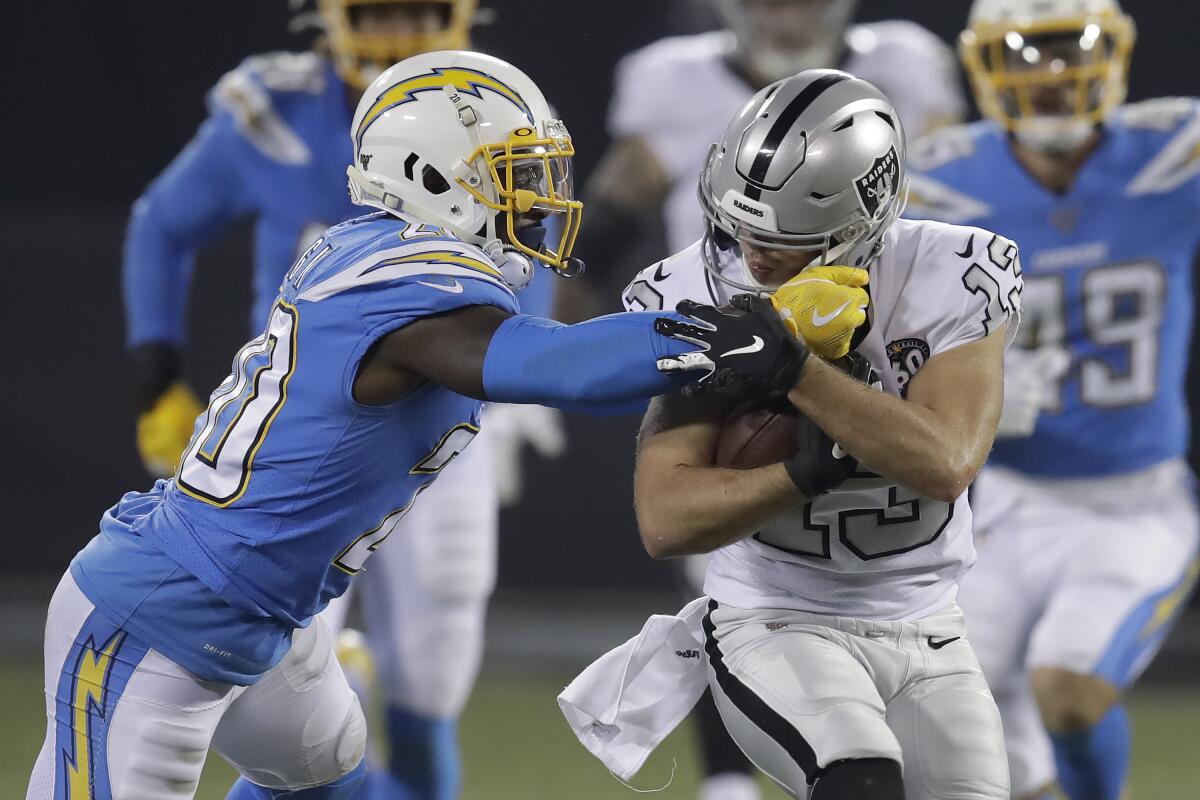 Oakland Raiders wide receiver Hunter Renfrow, right, runs against Los Angeles Chargers defensive back Desmond King II (20) during the second half of an NFL football game in Oakland, Calif., Thursday, Nov. 7, 2019. (AP Photo/Ben Margot)