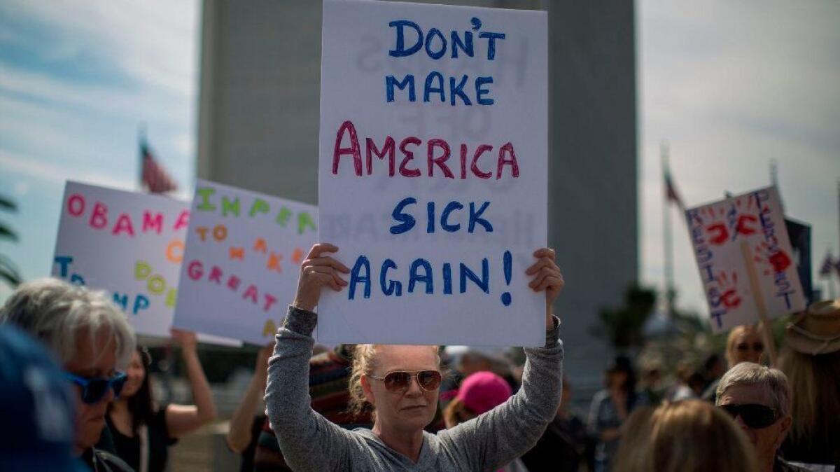 People protest Trump administration policies that threaten the Affordable Care Act, Medicare and Medicaid, near the Wilshire Federal Building in Los Angeles on Feb. 25, 2017.