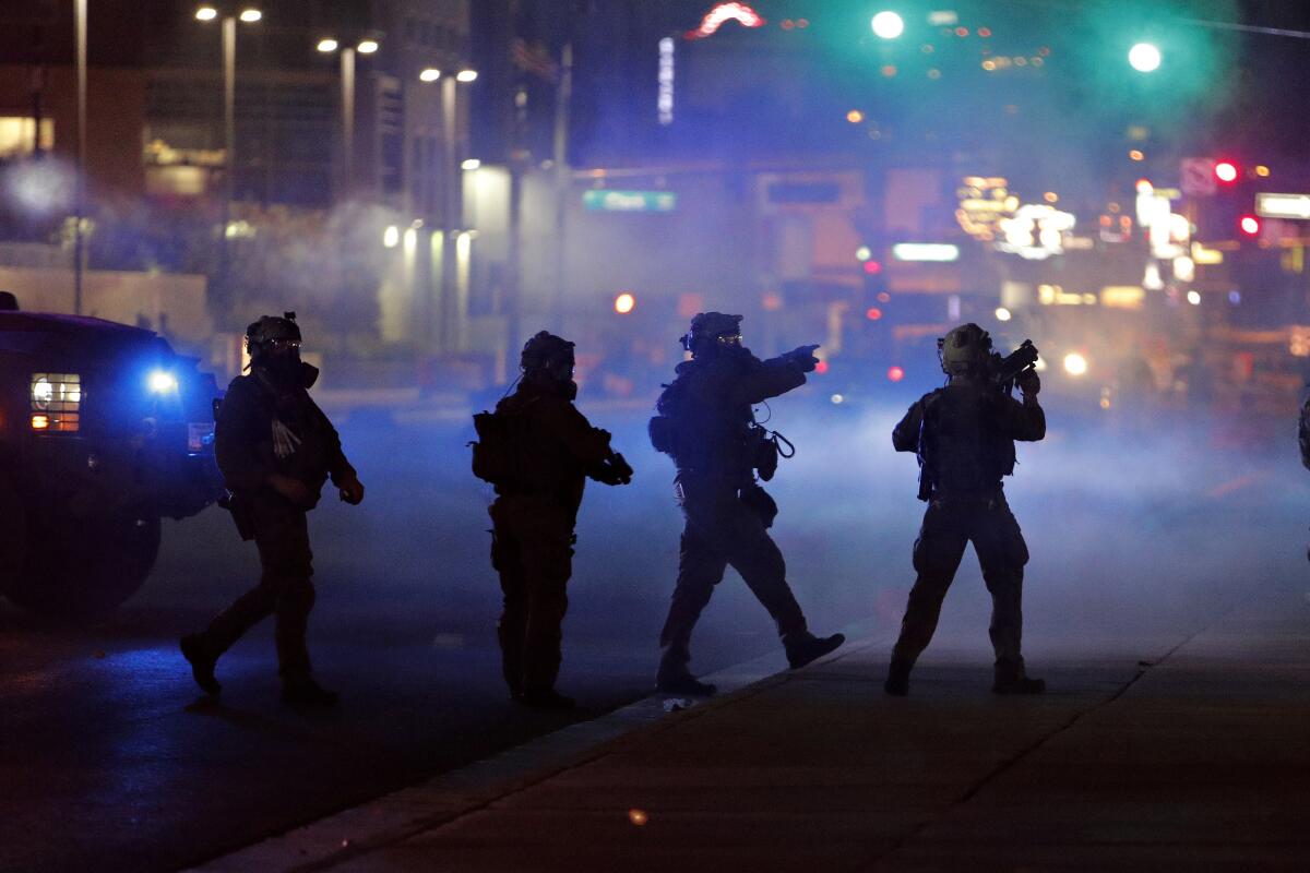 Police walk through tear gas as they try to disperse protesters in Las Vegas last week.