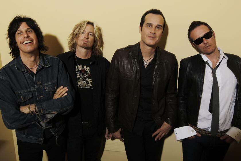 Scott Weiland, right, has disputed his Stone Temple Pilots bandmates' claim that he's been fired from the grunge-era group.