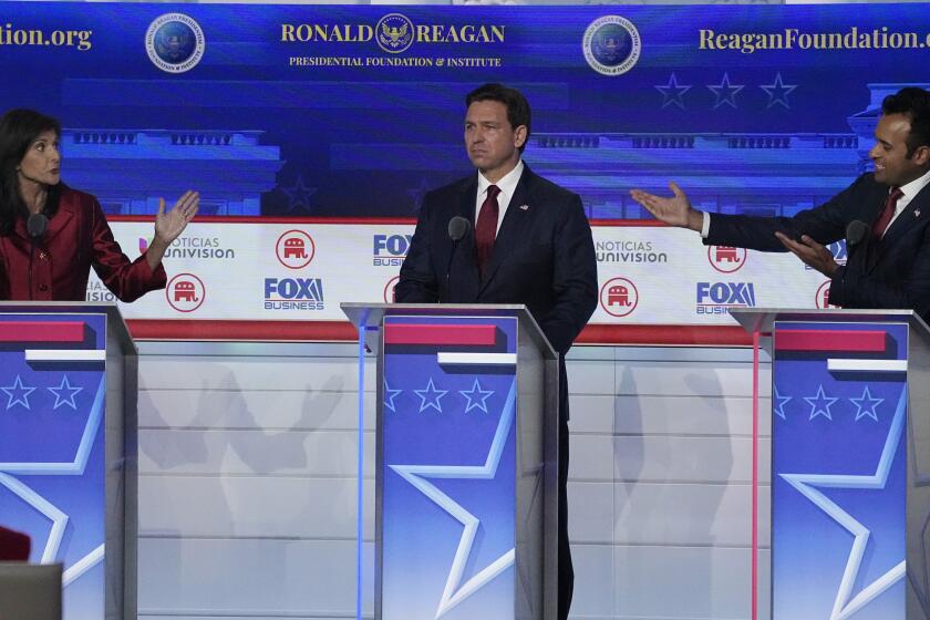 Former U.N. Ambassador Nikki Haley, left, argues a point with businessman Vivek Ramaswamy, right, between Florida Gov. Ron DeSantis, center, during a Republican presidential primary debate hosted by FOX Business Network and Univision, Wednesday, Sept. 27, 2023, at the Ronald Reagan Presidential Library in Simi Valley, Calif. (AP Photo/Mark J. Terrill)