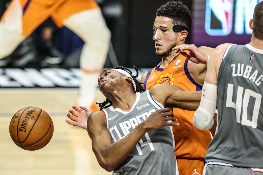 Saturday, June 26, 2021, Los Angeles CA - LA Clippers guard Terance Mann (14) is fouled by Phoenix Suns guard Devin Booker (1) late in the first half in Game four of the NBA Western Conference Finals at Staples Center. (Robert Gauthier/Los Angeles Times)